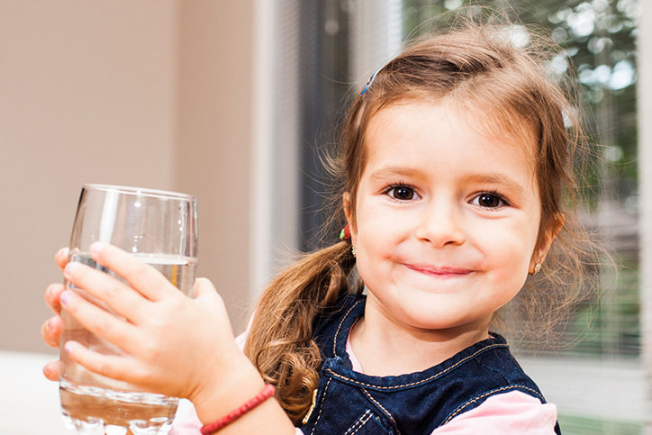little girl with glass of water
